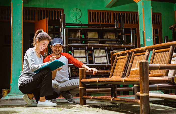 TGEI Asian Woman and Asian male looking at bamboo chairs 