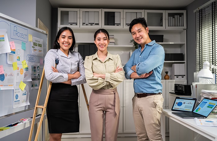 A female with a disability with a female and male in an office 